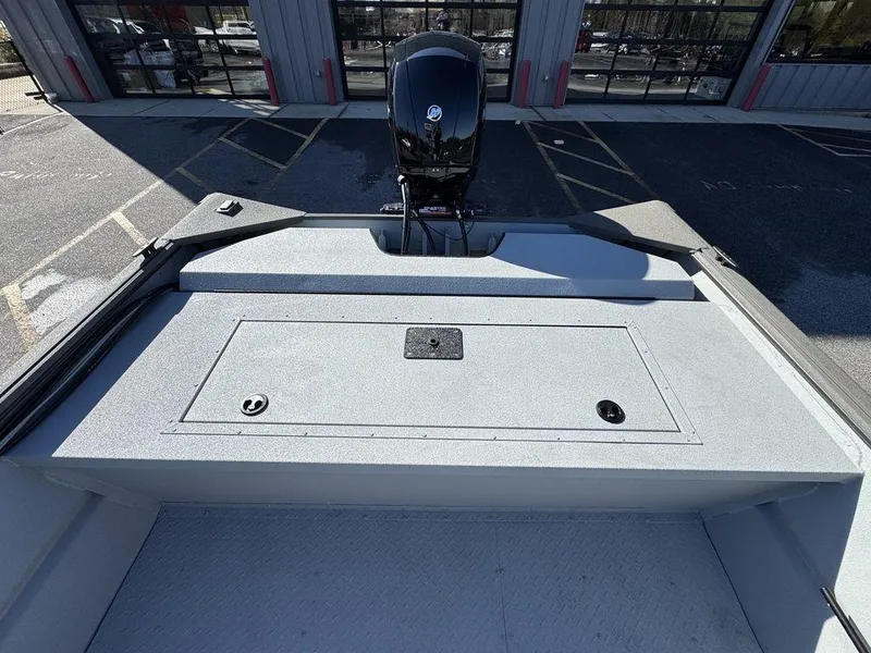 Slide: The Image of 2025 SeaArk 2072 MV Flat Cat boat, rear view with motor and storage compartment. - 10