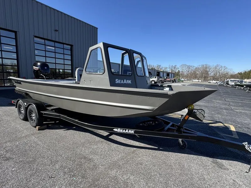 Slide: The Image of 2025 SeaArk 2072 MV Flat Cat boat on trailer, parked outdoors. - 2