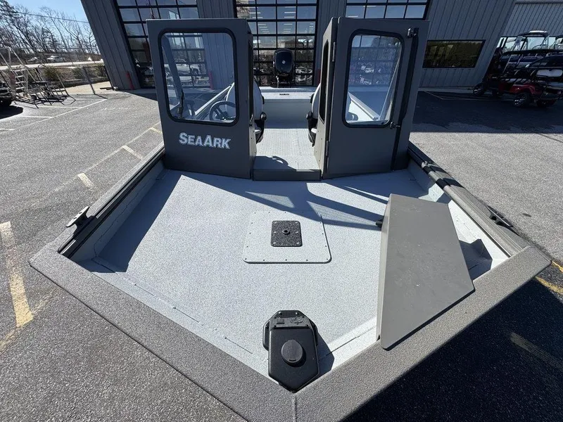 Slide: The Image of 2025 SeaArk 2072 MV Flat Cat boat, gray deck, dual windshields, parked outdoors. - 4