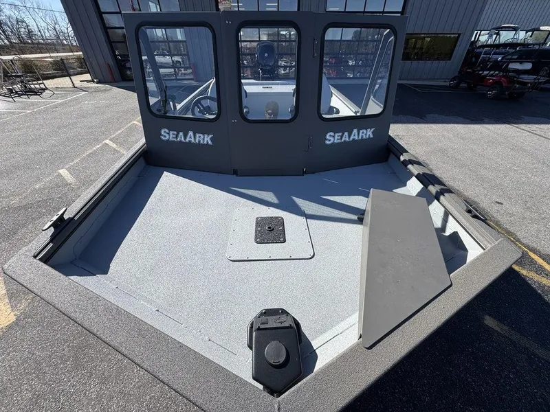 Slide: The Image of 2025 SeaArk 2072 MV Flat Cat boat, front deck view, parked outdoors. - 5