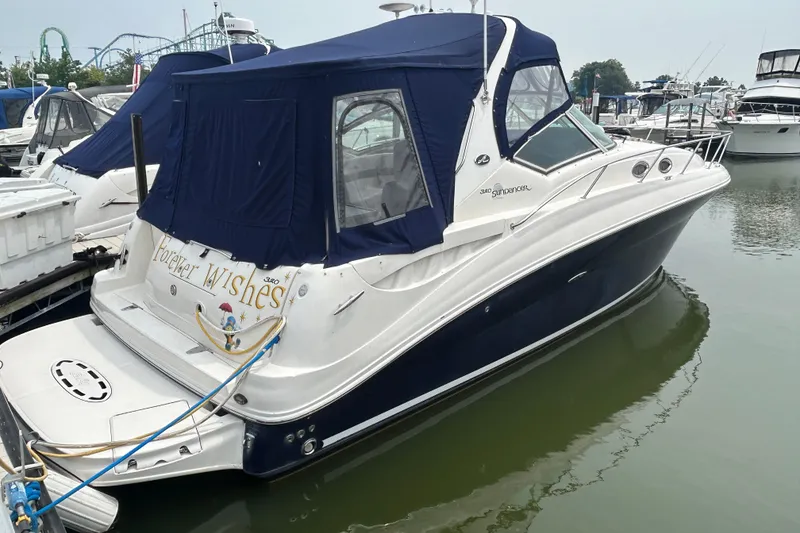Slide: The Image of 2005 Sea Ray 320 Sundancer docked with blue canopy in marina. - 0