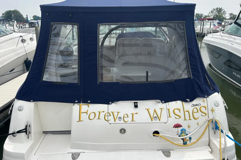 Slide: The Image of 2005 Sea Ray 320 Sundancer boat named "Forever Wishes" docked at a marina. - 10