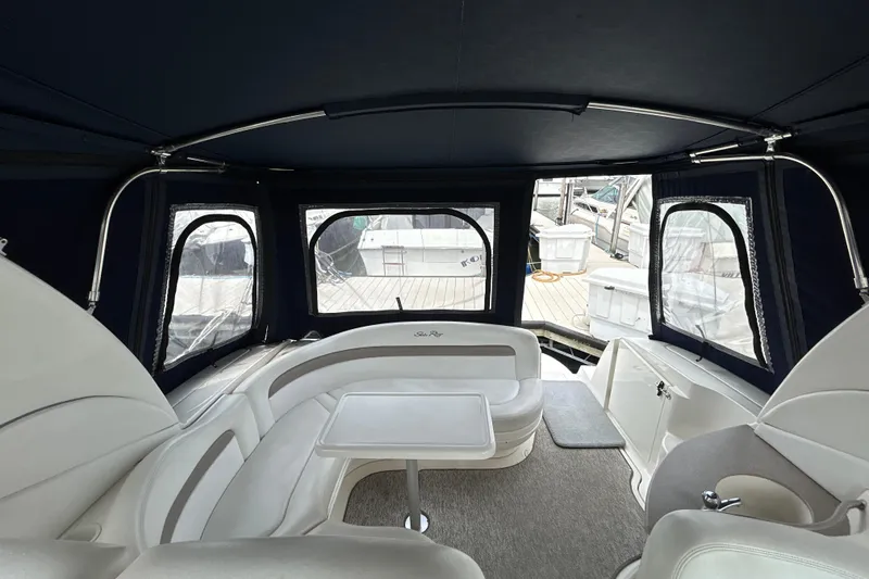 Slide: The Image of 2005 Sea Ray 320 Sundancer interior with seating and table, docked at marina. - 14