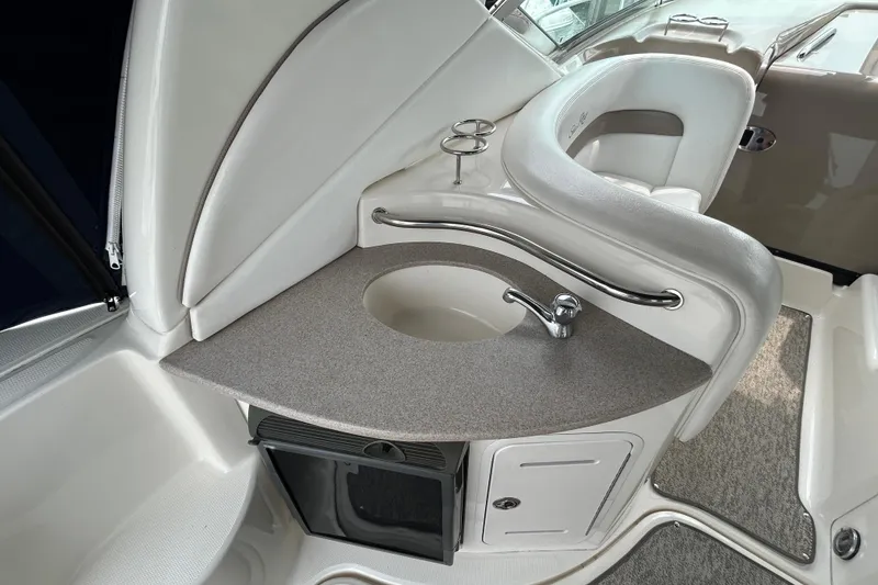 Slide: The Image of 2005 Sea Ray 320 Sundancer boat interior with sink and seating area. - 19