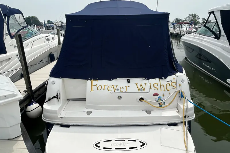 Slide: The Image of 2005 Sea Ray 320 Sundancer boat named "Forever Wishes" docked at marina. - 2