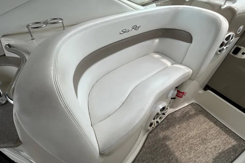 Slide: The Image of White leather seating on 2005 Sea Ray 320 Sundancer boat, featuring cup holders and speakers. - 22