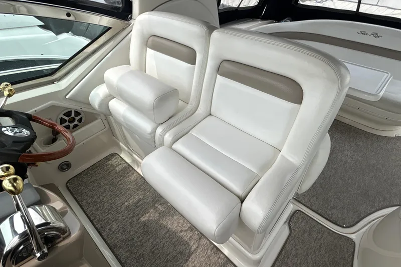 Slide: The Image of Luxurious interior of 2005 Sea Ray 320 Sundancer with plush white seating. - 28