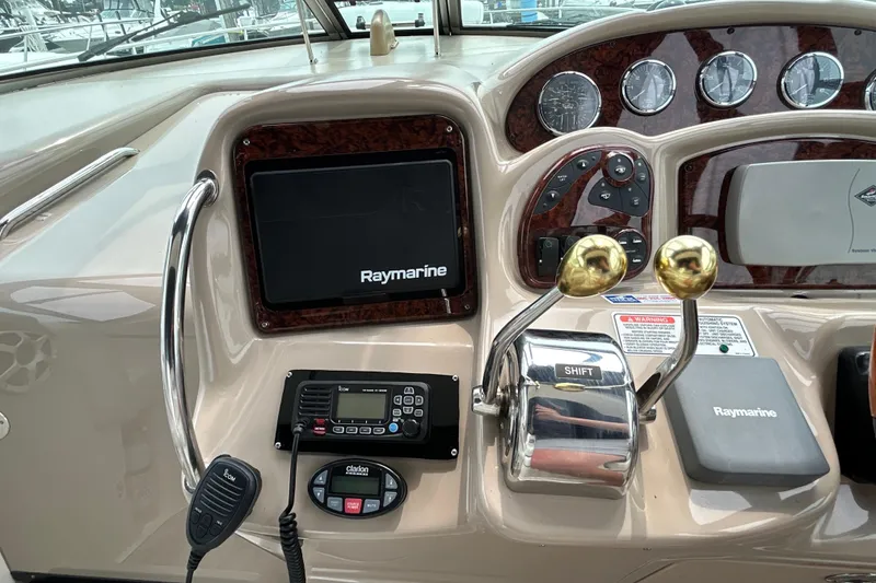 Slide: The Image of Control panel of a 2005 Sea Ray 320 Sundancer with Raymarine electronics and dual throttle levers. - 30
