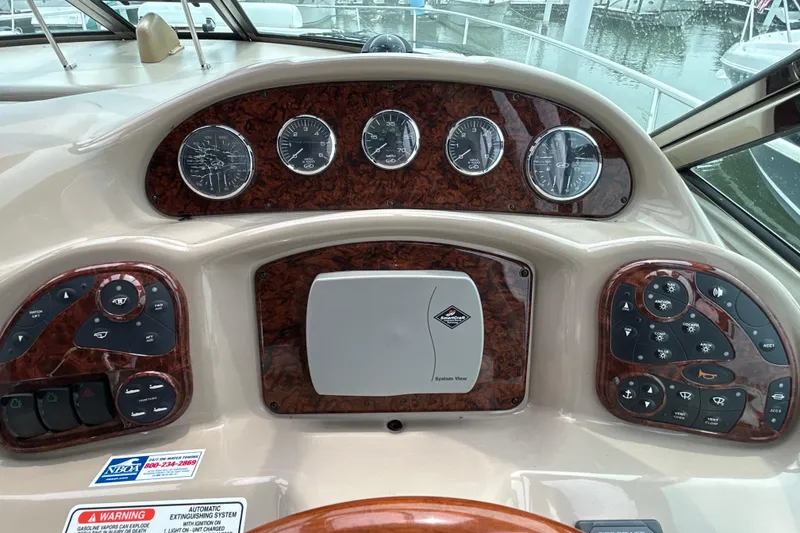 Slide: The Image of Dashboard of a 2005 Sea Ray 320 Sundancer boat with gauges and controls. - 31