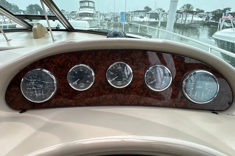 Slide: The Image of Dashboard of 2005 Sea Ray 320 Sundancer with gauges, marina view in background. - 32