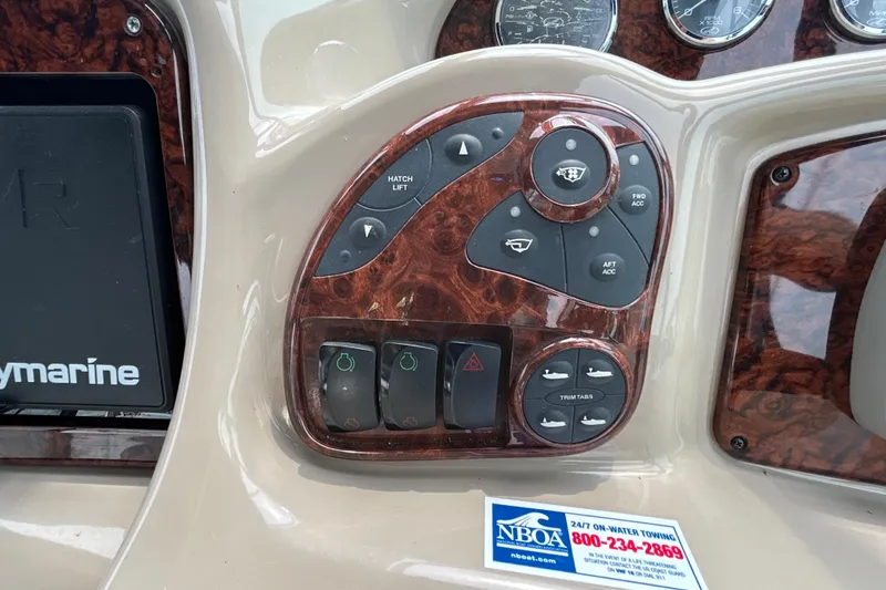 Slide: The Image of Control panel of a 2005 Sea Ray 320 Sundancer boat with various switches and buttons. - 38