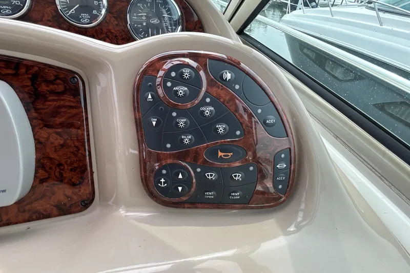 Slide: The Image of Control panel of a 2005 Sea Ray 320 Sundancer boat with various switches and gauges. - 39