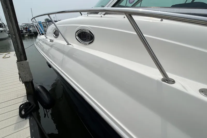 Slide: The Image of 2005 Sea Ray 320 Sundancer docked at marina, side view. - 4