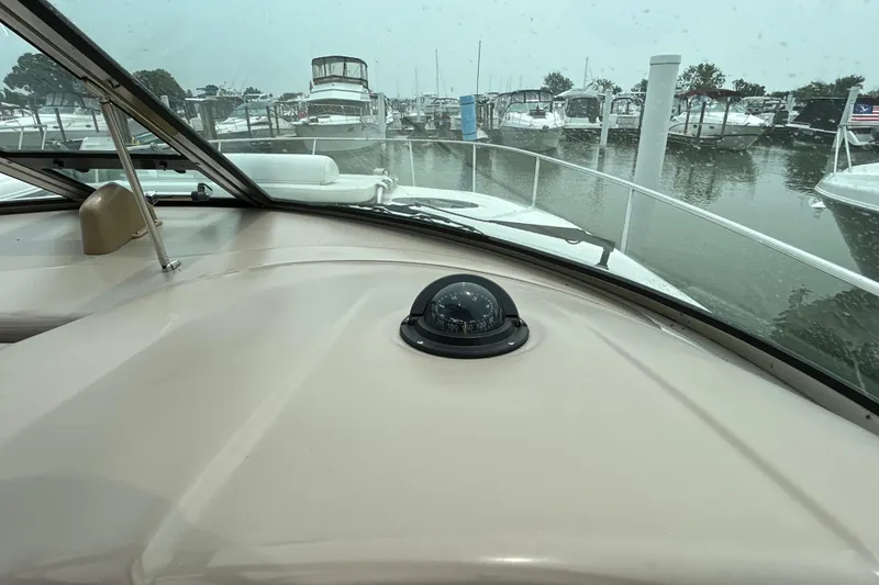 Slide: The Image of 2005 Sea Ray 320 Sundancer cockpit view with compass, docked in marina. - 40