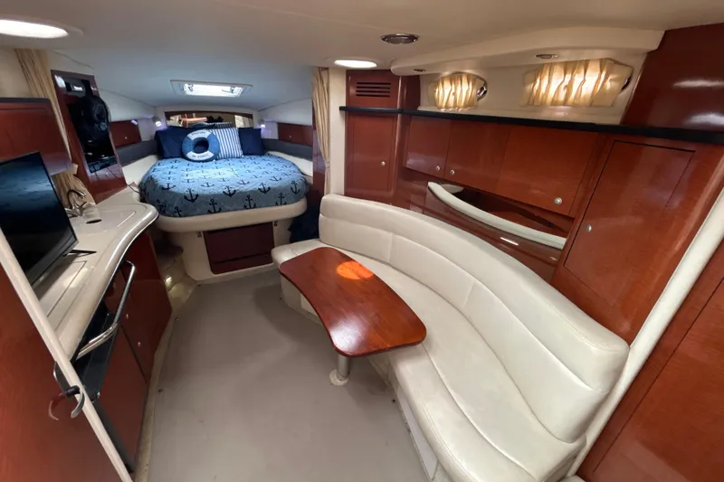 Slide: The Image of Luxurious interior of 2005 Sea Ray 320 Sundancer with cozy bed and elegant seating area. - 41