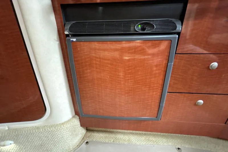 Slide: The Image of Wood-paneled mini fridge in 2005 Sea Ray 320 Sundancer yacht interior. - 47