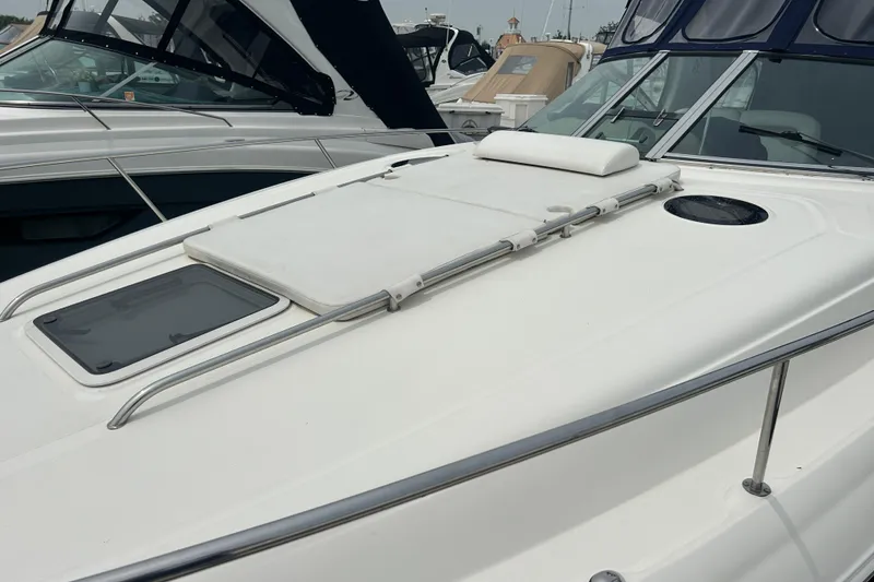 Slide: The Image of 2005 Sea Ray 320 Sundancer boat deck with sunpad and railing. - 5