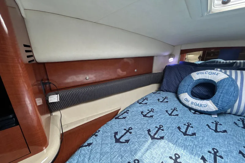 Slide: The Image of Interior cabin of 2005 Sea Ray 320 Sundancer with nautical-themed bedding. - 50