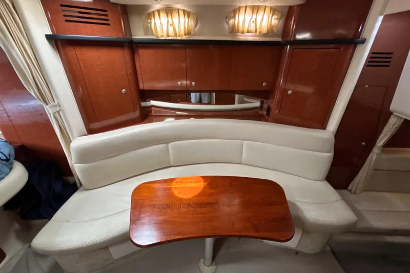 Slide: The Image of Luxurious interior of 2005 Sea Ray 320 Sundancer with elegant wood and leather seating. - 53