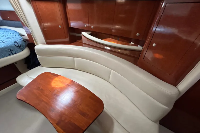 Slide: The Image of Luxurious interior of 2005 Sea Ray 320 Sundancer with elegant wood and leather seating. - 54