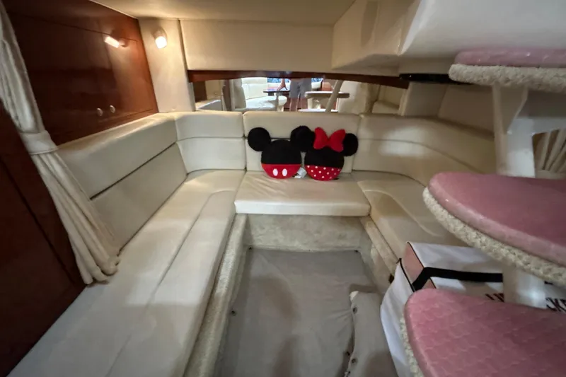 Slide: The Image of Interior of 2005 Sea Ray 320 Sundancer with cozy seating and decorative cushions. - 55