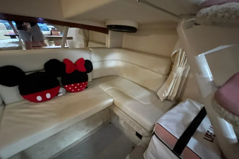 Slide: The Image of Interior of 2005 Sea Ray 320 Sundancer with plush seating and decorative pillows. - 58