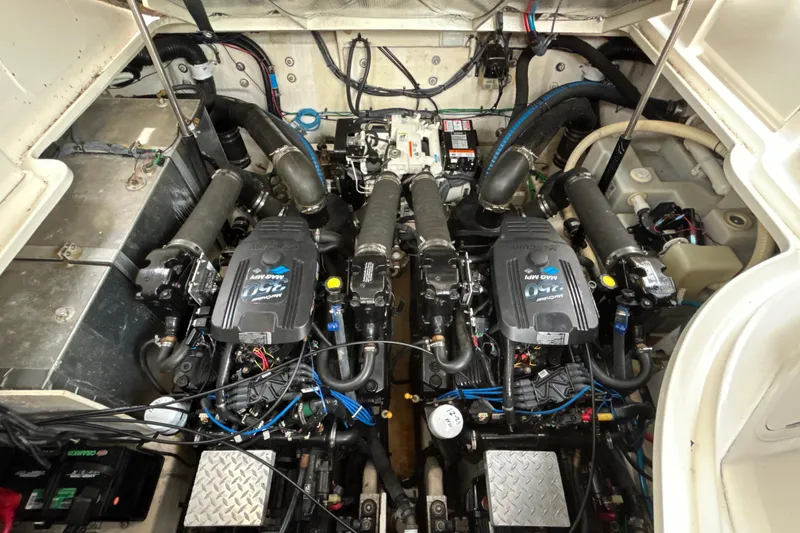 Slide: The Image of Engine compartment of a 2005 Sea Ray 320 Sundancer, showcasing dual engines and mechanical components. - 62