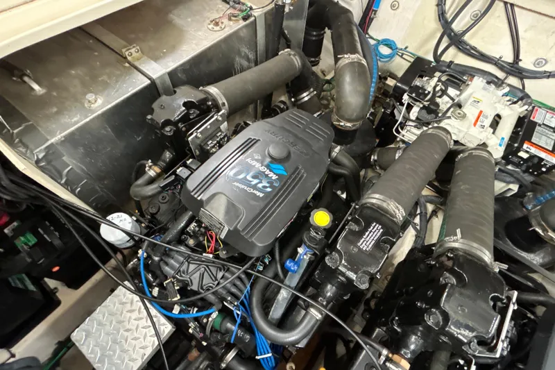 Slide: The Image of Engine compartment of a 2005 Sea Ray 320 Sundancer boat, showcasing mechanical components. - 64