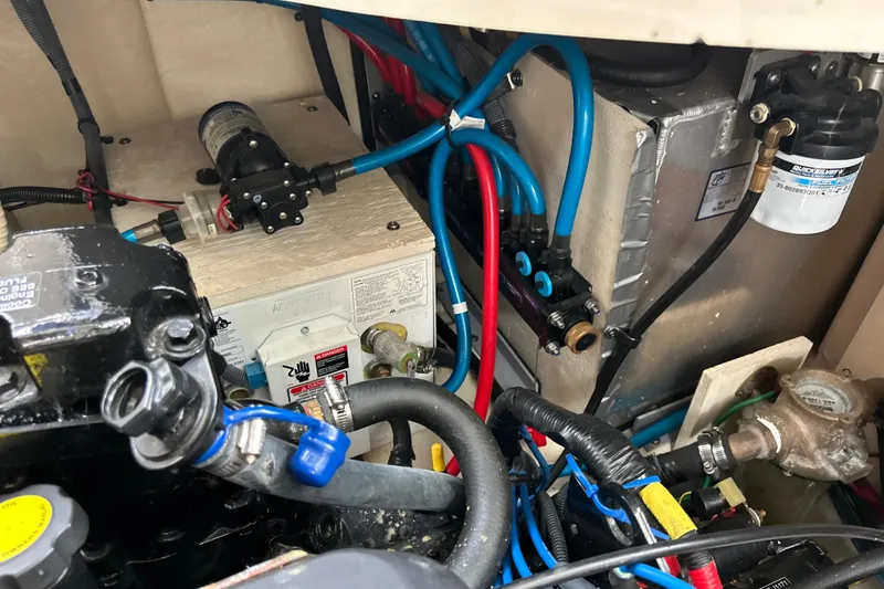 Slide: The Image of Engine compartment of a 2005 Sea Ray 320 Sundancer with visible wiring and components. - 65