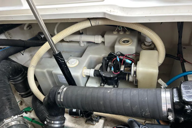 Slide: The Image of Engine compartment of a 2005 Sea Ray 320 Sundancer with hoses and mechanical components. - 67