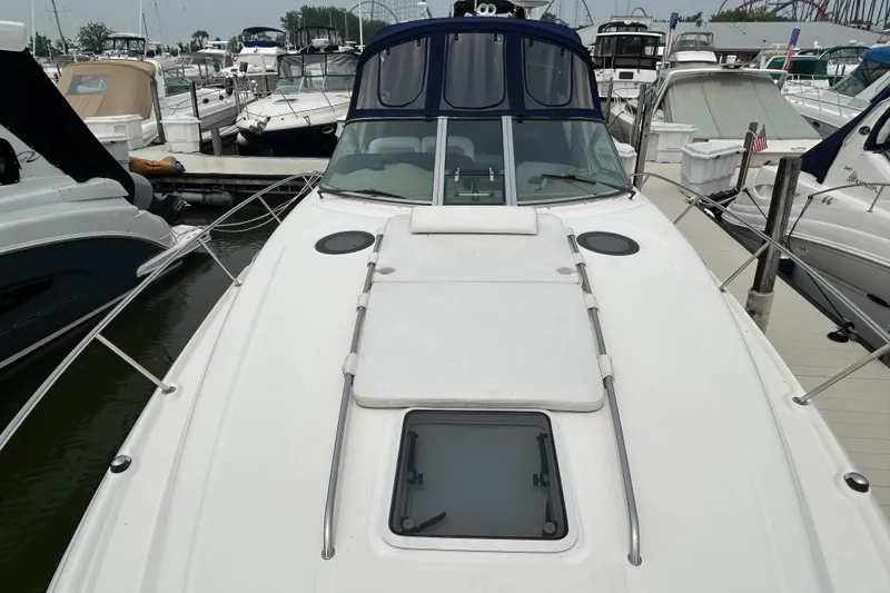Slide: The Image of 2005 Sea Ray 320 Sundancer docked at marina, surrounded by other boats. - 9