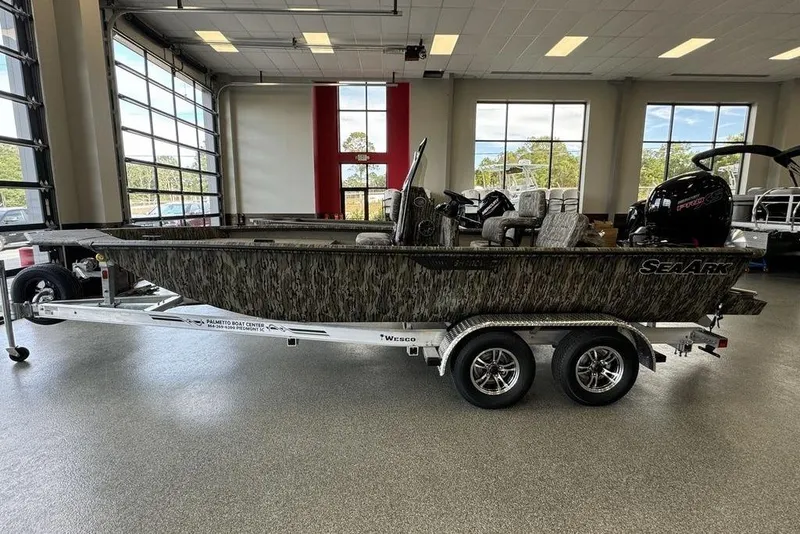 The Image of 2026 SeaArk Shadow 20 Elite CC boat on trailer in showroom. - 1