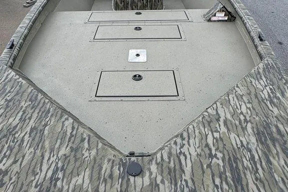 Slide: The Image of 2026 SeaArk Shadow 20 Elite CC boat with camo design and storage compartments. - 11