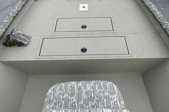 Slide: The Image of 2026 SeaArk Shadow 20 Elite CC boat interior with camo seating and storage compartments. - 13