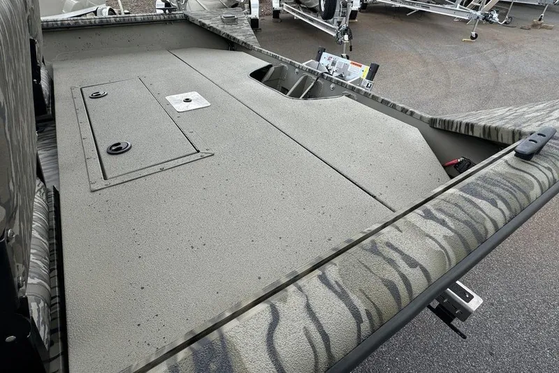 Slide: The Image of 2026 SeaArk Shadow 20 Elite CC boat deck with storage compartments. - 15