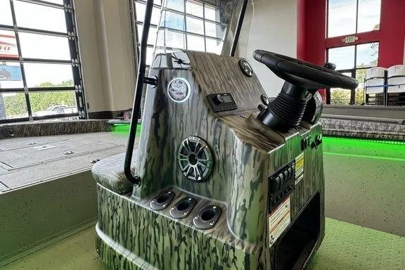 Slide: The Image of 2026 SeaArk Shadow 20 Elite CC boat console with camouflage design and modern controls. - 5