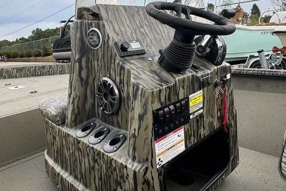 Slide: The Image of 2026 SeaArk Shadow 20 Elite CC boat console with camouflage design and modern controls. - 8