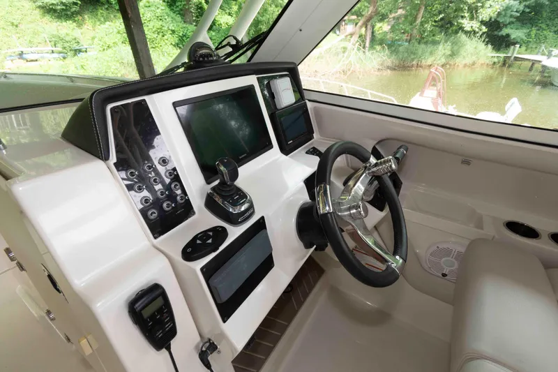 Slide: The Image of 2020 Sailfish 325 DC boat cockpit with modern steering and control panel. - 10