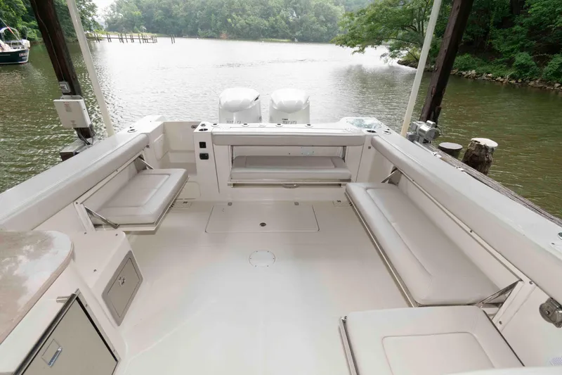 Slide: The Image of 2020 Sailfish 325 DC boat interior with spacious seating and scenic water view. - 12