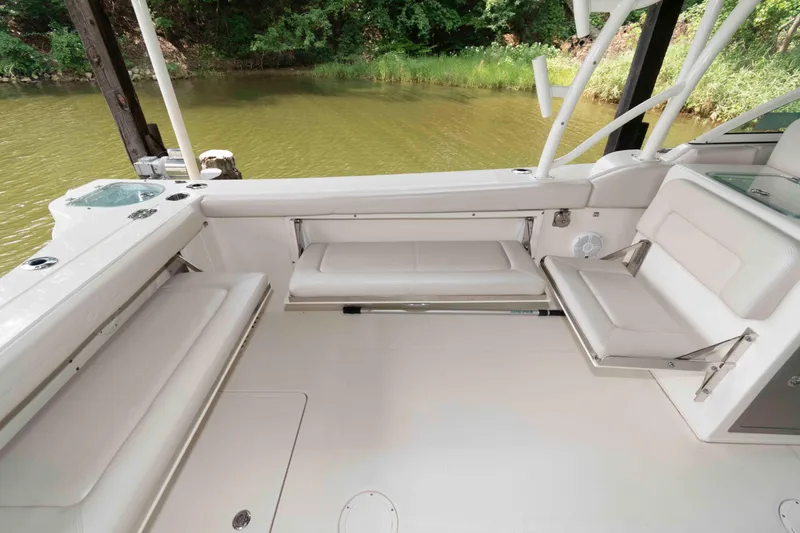 Slide: The Image of 2020 Sailfish 325 DC boat interior with white seating and scenic water view. - 13