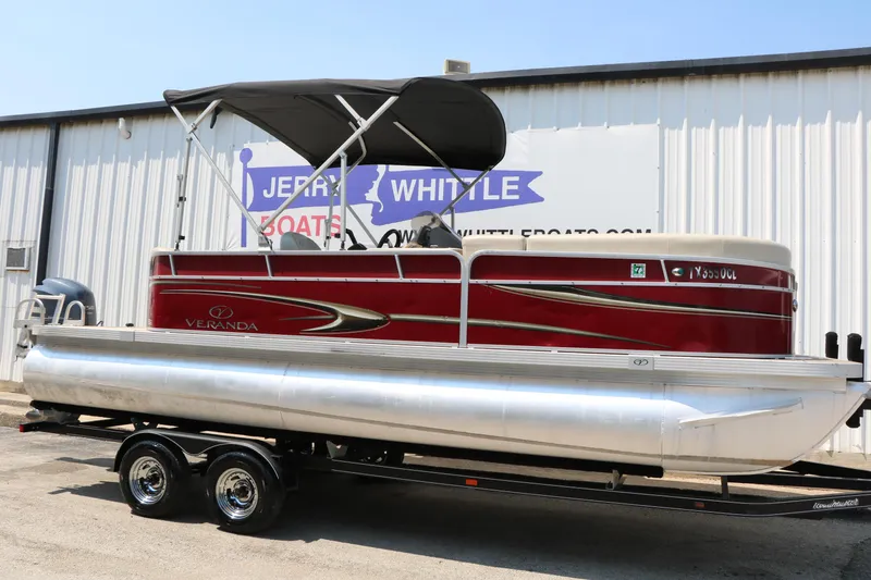 Slide: The Image of 2014 Veranda Relax V2275 pontoon boat with red exterior on a trailer. - 1