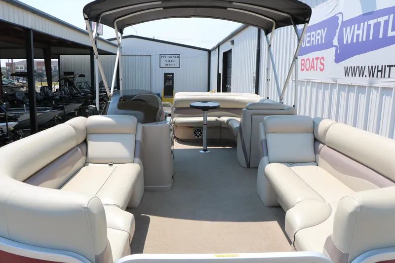 Slide: The Image of 2014 Veranda Relax V2275 pontoon boat with spacious seating and canopy, displayed at a dealership. - 10