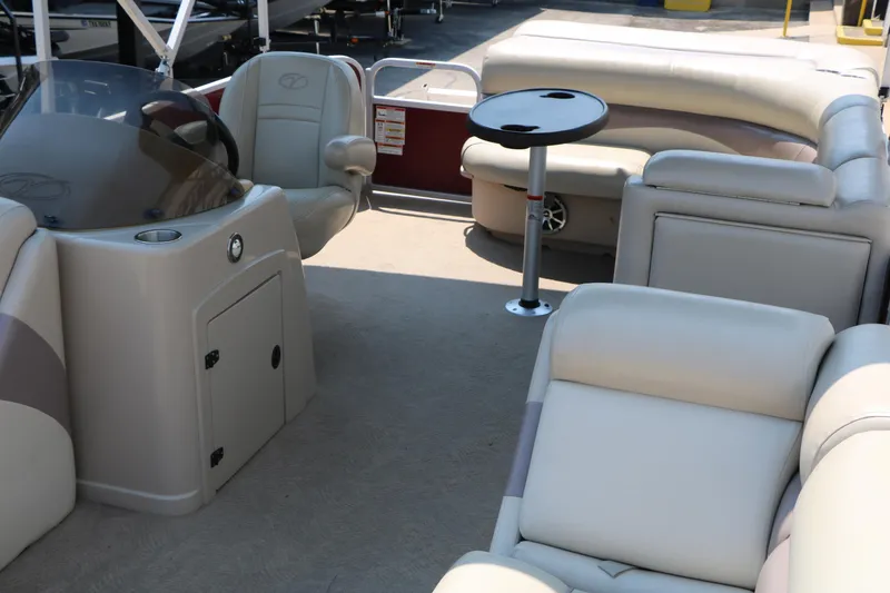 Slide: The Image of 2014 Veranda Relax V2275 pontoon boat interior with plush seating and table. - 14