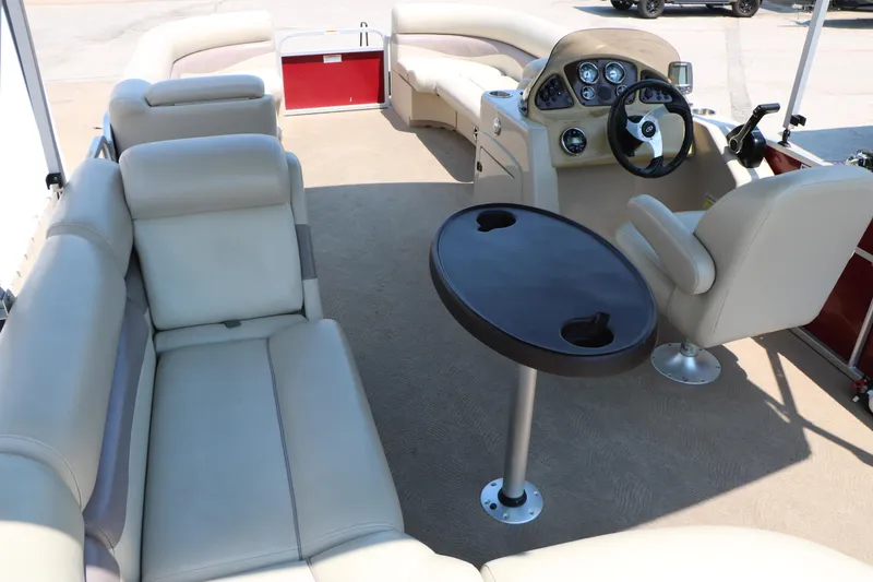 Slide: The Image of 2014 Veranda Relax V2275 pontoon boat interior with beige seating and steering console. - 16