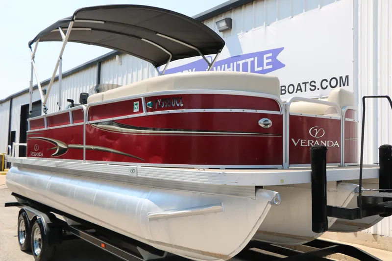 Slide: The Image of 2014 Veranda Relax V2275 pontoon boat with red exterior and canopy, on trailer. - 4