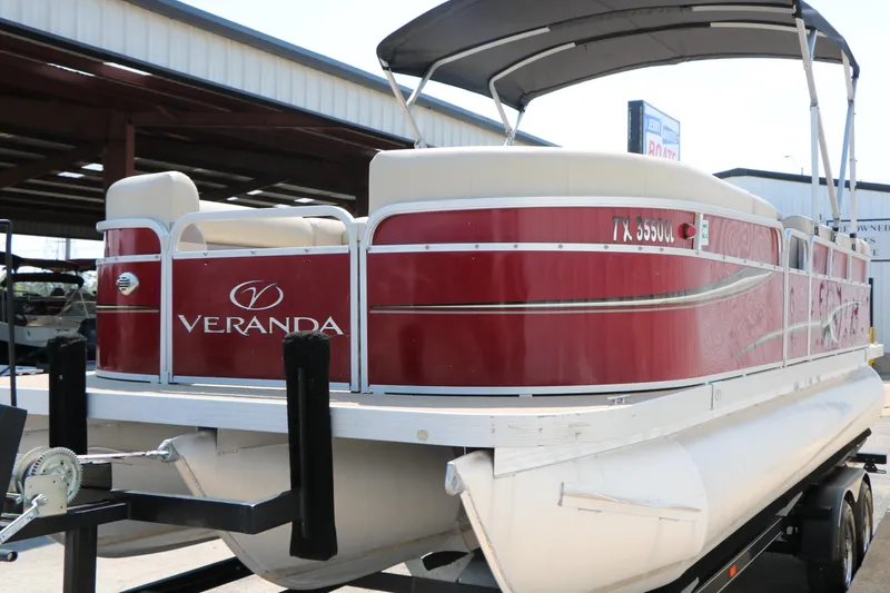 Slide: The Image of 2014 Veranda Relax V2275 pontoon boat with red exterior on a trailer. - 6