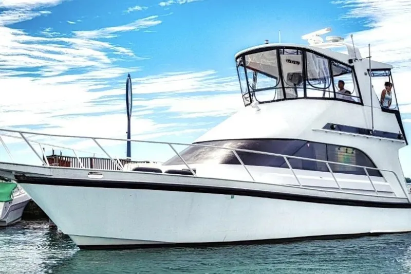 The Image of 1987 Davidson 48 Sportfish yacht on water under clear blue sky. - 1