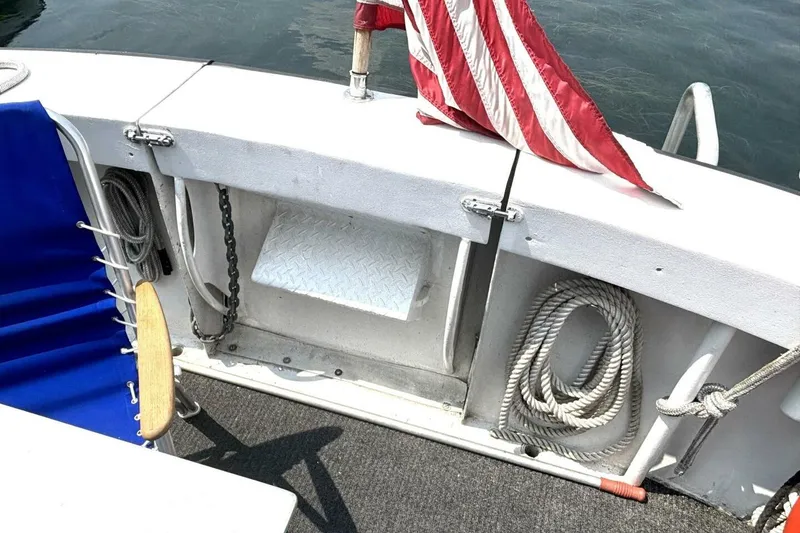 Slide: The Image of 1987 Davidson 48 Sportfish deck with American flag, ropes, and blue chair. - 17