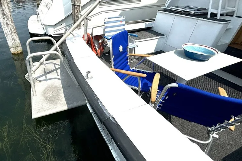 Slide: The Image of 1987 Davidson 48 Sportfish boat deck with chairs and table setup. - 19