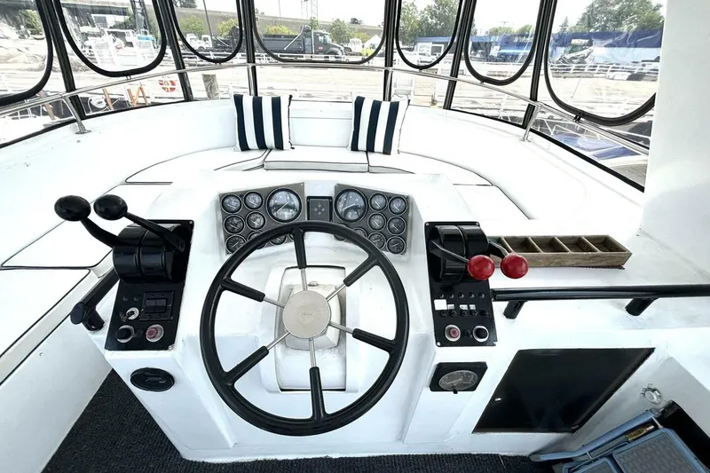 Slide: The Image of Helm of 1987 Davidson 48 Sportfish boat with steering wheel and control panels. - 24